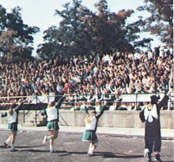 Mehlville students cover the bleachers beside the football field in the 1971 homecoming pep rally. 