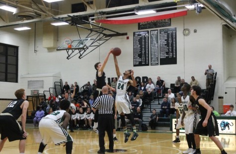 Jan. 8 - Senior, Colby Maynard leaps up for the opening tip-off against Lafayette. 