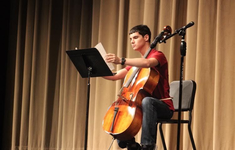 Justin Batres prepares for a Cello solo of "Minuet No. 3"