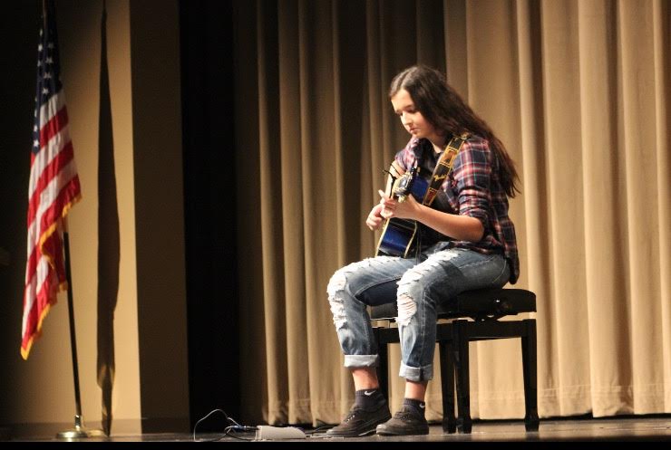 Amina Junuzovic performing a guitar solo of Justin Bieber's "Love Yourself" 