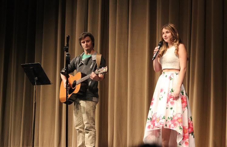 Shelby Bouren sings "Am I Not Pretty Enough" as Jack Young plays the guitar. 