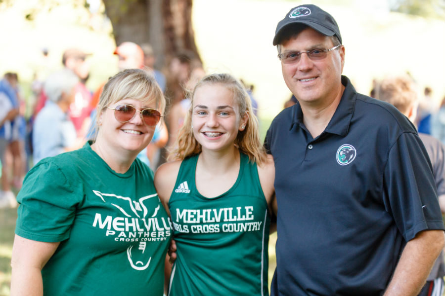 Photo courtesy of Stephanie Lowry || Emma and her family pose for a quick photo during a track meet.