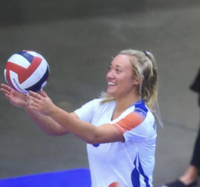 Johnson prepares to serve the ball playing for her club team