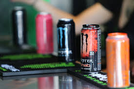 Cans of Monster in front of students.