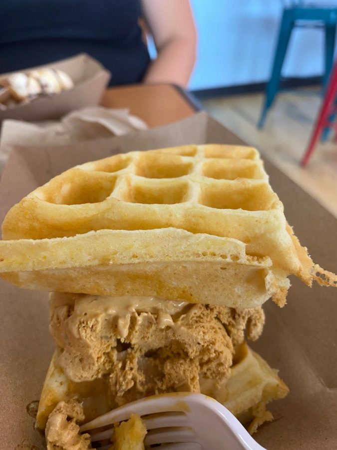 Customer enjoys a waffle ice cream sandwich.