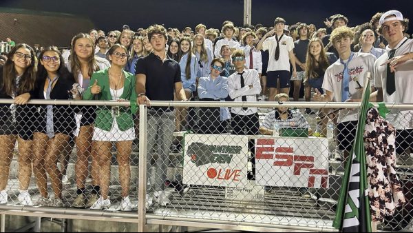 Green Pit cheering on their football team under the Friday night lights. 