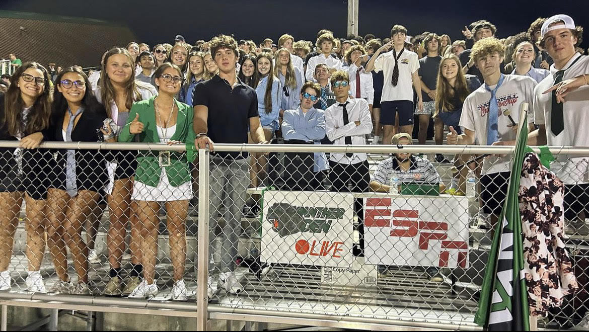Green Pit cheering on their football team under the Friday night lights. 