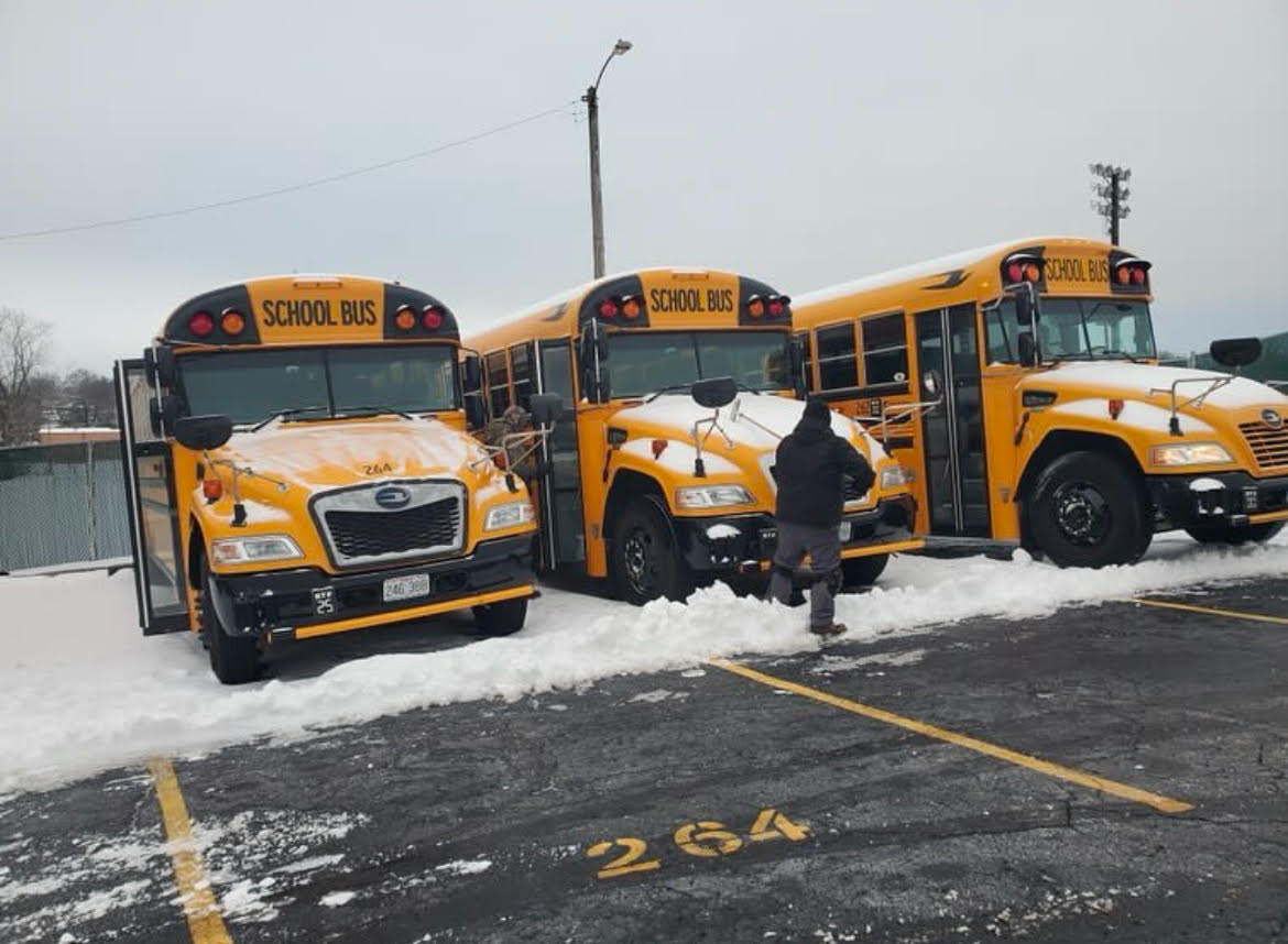 Facilities crew works to clear buses.