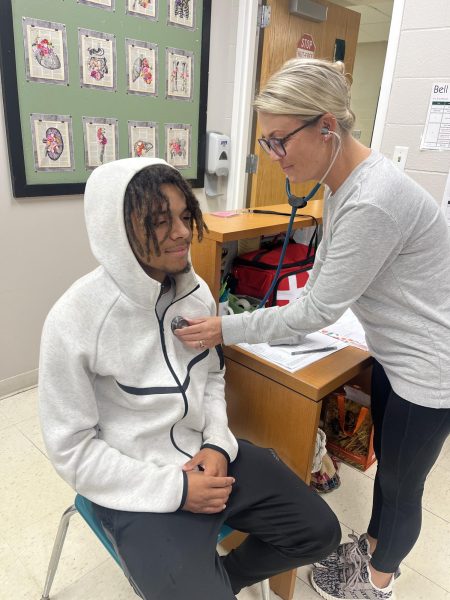 Nurse Stephanie in checking up on a student 