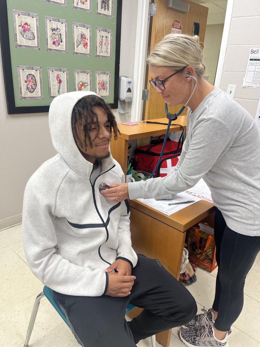 Nurse Stephanie in checking up on a student 
