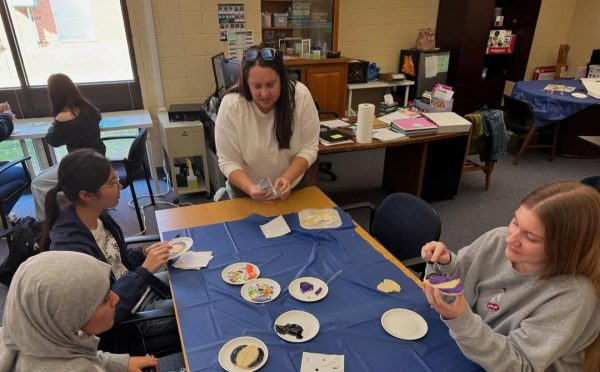 Members decorate cookies at the Halloween party.
