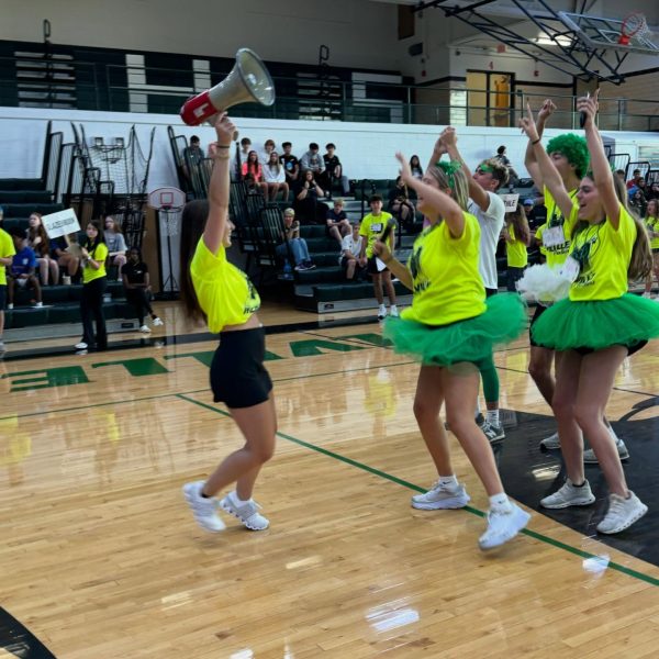Seniors Regan Henderson, Annabelle Meyer, Riley Harper, Brady Sights and Cooper Riek hype up the incoming freshmen crowd at kickoff on Aug. 12, 2024.