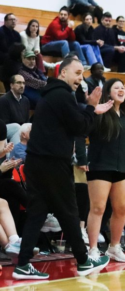 Coach Cook cheers on the team.
